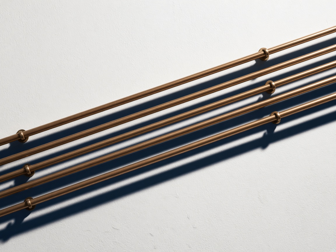 Parallel copper conduit on a plaster wall
